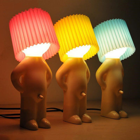 Shy little boy reading lamp