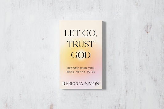 Book titled 'Let Go, Trust God' by Rebecca Simon on a light wooden surface