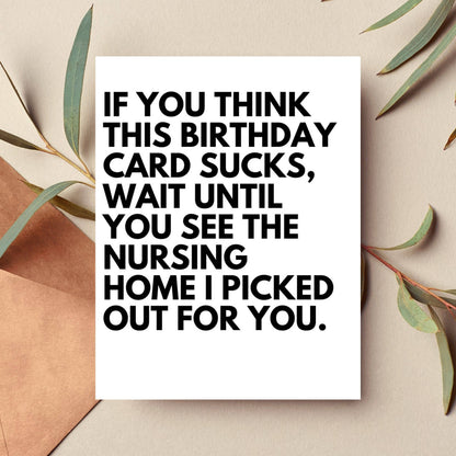 Birthday card with humorous text on a beige background with leaves