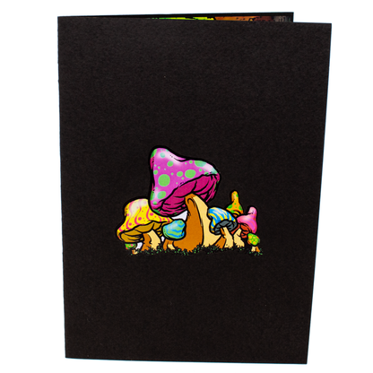 Black notebook with colorful mushroom design on a white background
