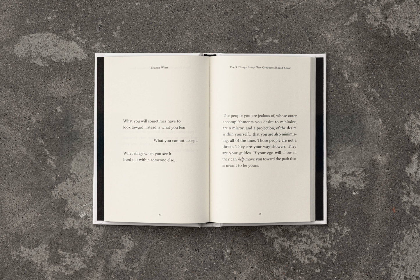 Open book with text on a textured gray surface