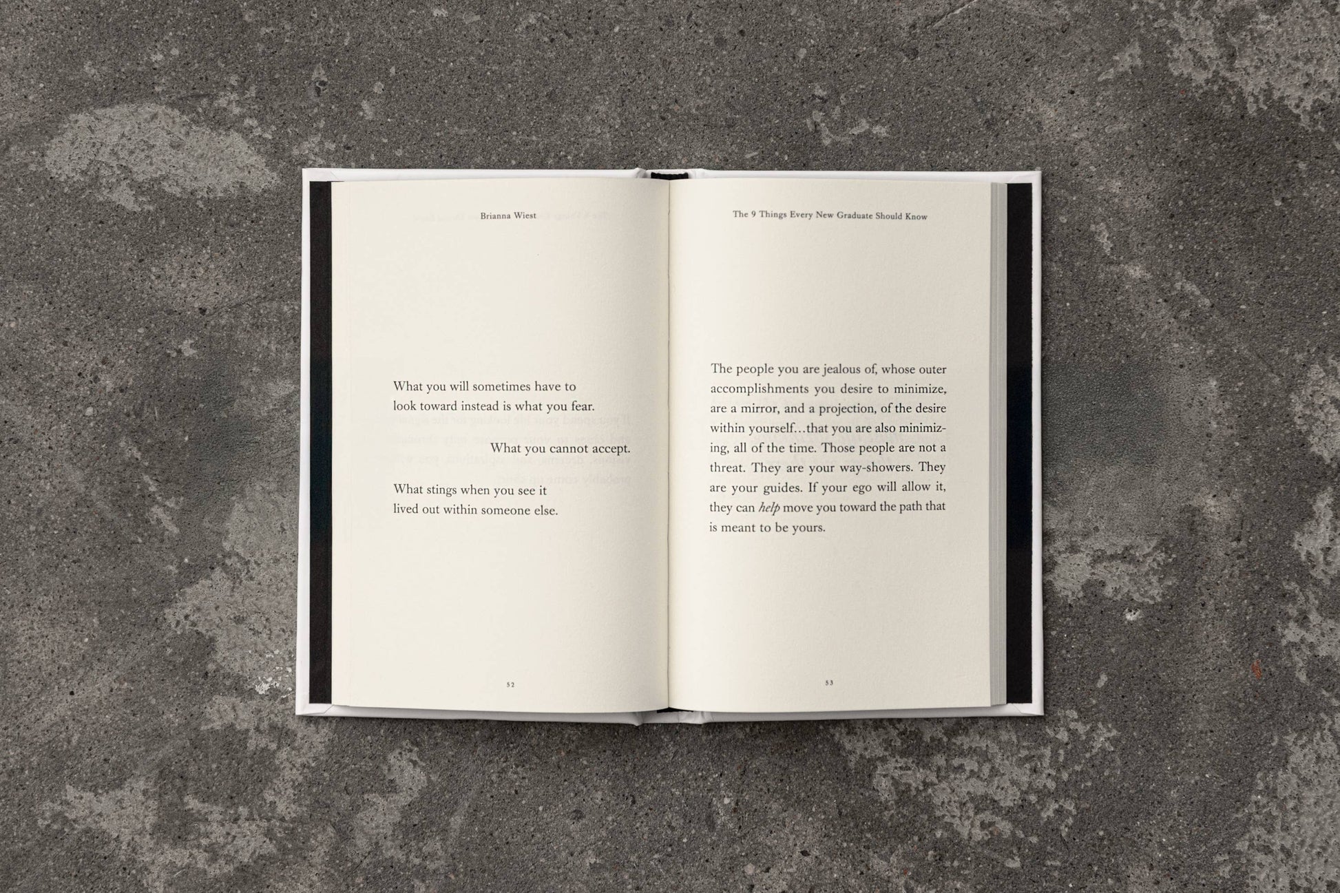 Open book with text on a textured gray surface