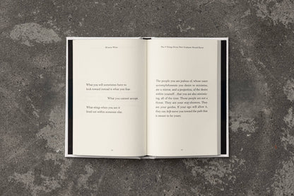 Open book with text on a textured gray surface