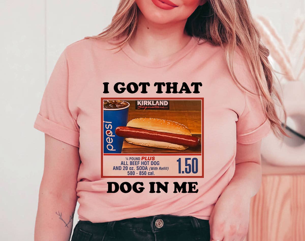 Person wearing a pink t-shirt with a graphic design and text.