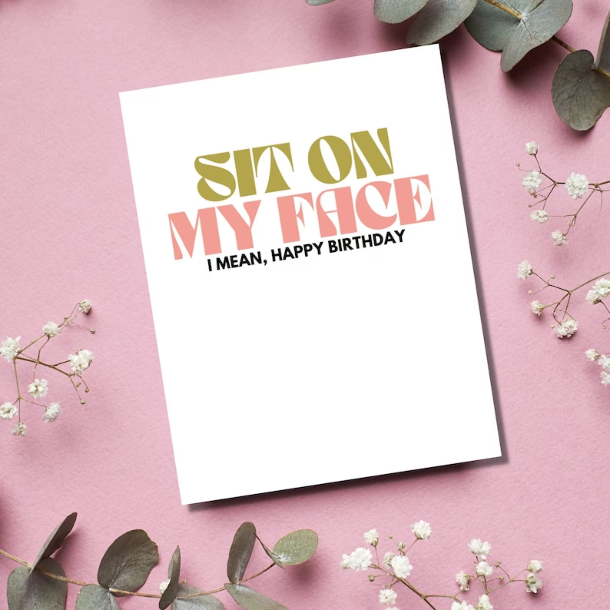 Birthday card with humorous text on a pink background with flowers and leaves.