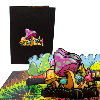 Colorful 3D pop-up card with mushrooms and gnomes on a white background