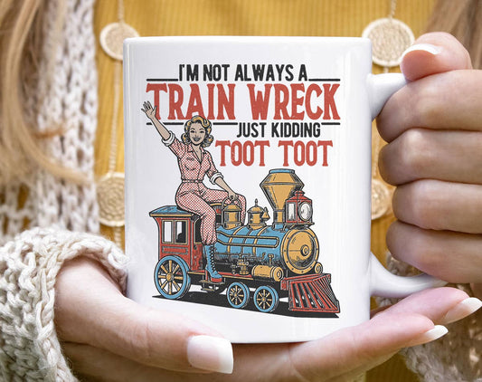 Mug with a train-themed design and text held by a person.