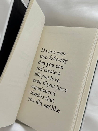 Open book with a motivational quote on a white background