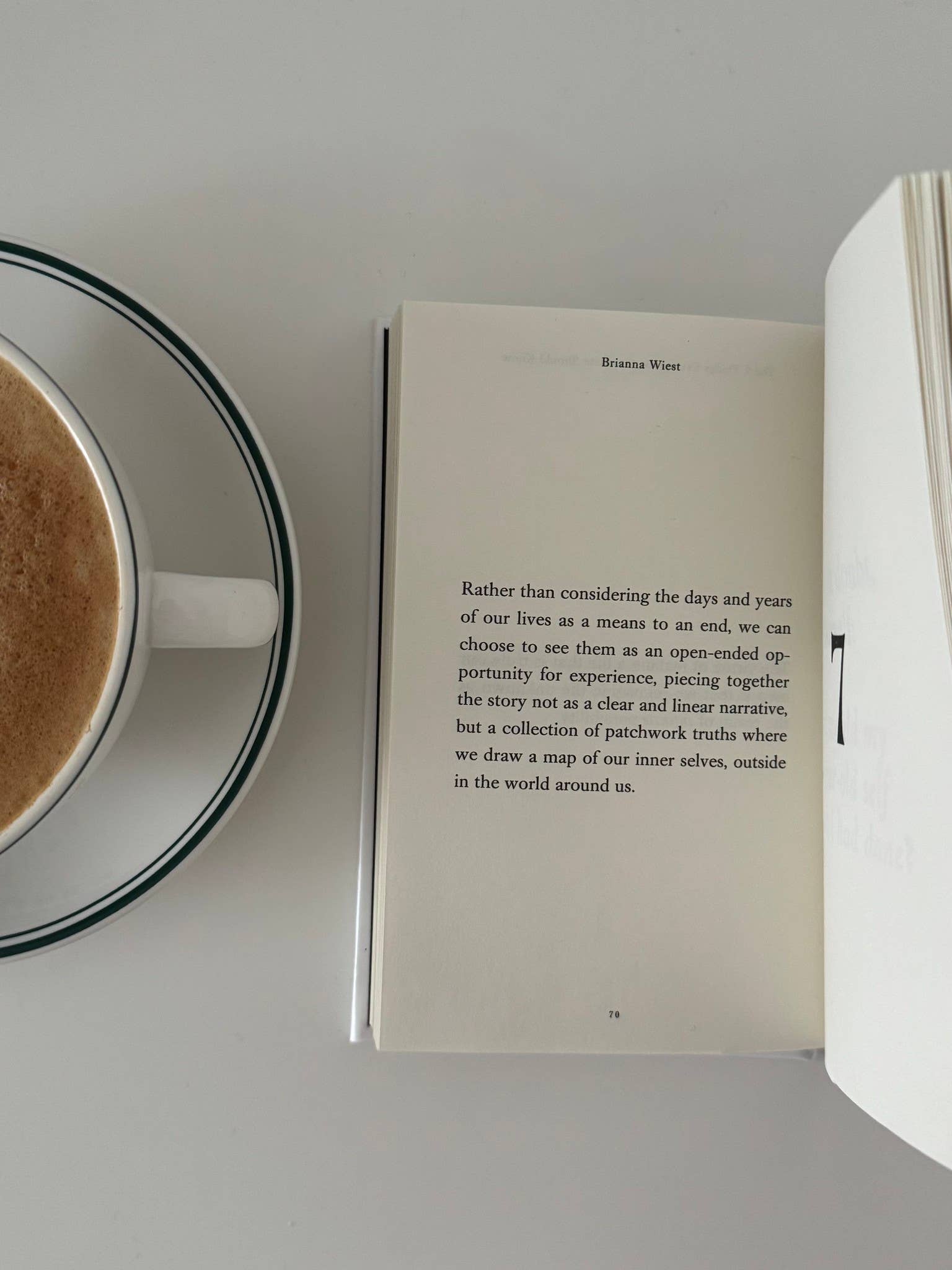 Open book with a cup of coffee on a white surface